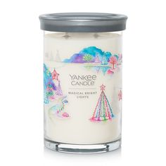 yankee candle with an image of christmas trees and stars on the front, in a glass jar