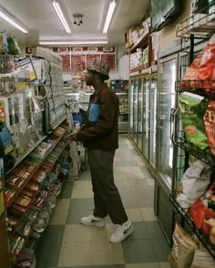 a man is standing in the aisle of a grocery store