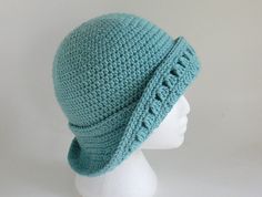 a crocheted hat on a mannequin head