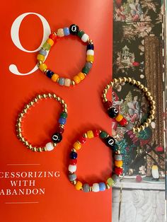 This set of 8 Ball colorful bracelets is crafted with precision, featuring 6mm gold plated beads and vibrant colored glass beads for a unique look. Each bracelet has a different color combination, so you can mix and match to create your own custom style. Multicolor Stretch Bracelet With Gold Beads As Gift, Multicolor Gold Beads Stretch Bracelet Gift, Gold Evil Eye Bracelet With Letter And Round Beads, 8 Ball, Colorful Bracelets, Color Combination, Mix And Match, Fashion Bracelets, Colored Glass