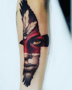 a man's arm with a native american style tattoo on it, and an orange eye