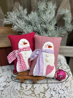 two snowmen sitting next to each other on a table