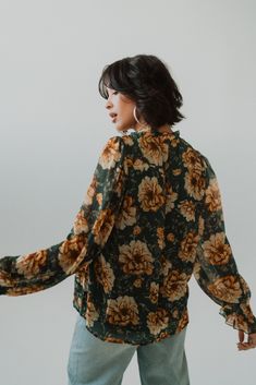 WOW WOW WOW, this floral top is stunning. Floral print Ruffled detailing Long sleeve, chiffon blouse Keyhole on front neckline with tie string Pleated detail on front chest Lined 100% polyester Model is 5'7" and wearing a size small. Small: 2-4 Medium: 6-8 Large: 10-12 Wow Wow Wow, Chiffon Blouse, Wow Products, Floral Top, Clothing Items, Floral Tops, Unique Style, Shirts Tops, Floral Print