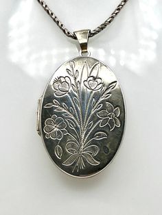 This vintage hallmarked sterling silver extra large locket is a timeless piece of jewellery. It features an oval pendant shape with a photo locket type that can hold large pictures of a loved ones. The locket comes with a 20-inch Byzantine style chain that adds to its elegant and classic look. Crafted with 925 sterling silver, this necklace has a high-quality construction that ensures its durability and longevity. The silver colour of the locket and chain matches well with any outfit, making it Pumpkin Jewelry, Large Locket, Sterling Silver Locket, Silver Locket, Photo Locket, Silver Lockets, Silver Colour, Outfit Making, Oval Pendant