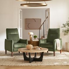 a living room with two green chairs and a coffee table