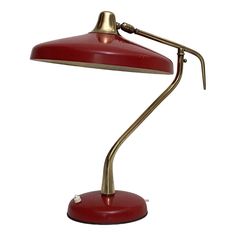 a red desk lamp on a white background