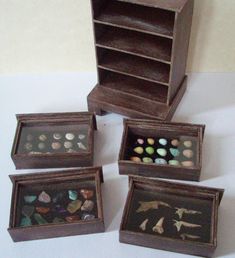 four wooden boxes with different types of rocks in them