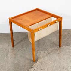 a small wooden table sitting on top of a cement floor