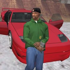 a man standing in front of a red car with the hood up and his hands in his pockets