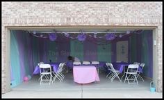 an outdoor event with tables and chairs set up in front of the entrance to the building