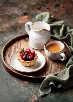 two cups and a plate with some food on it