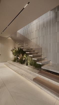 an indoor area with stairs and plants in the center, surrounded by white tiles on the walls