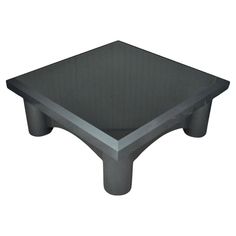 a black square table sitting on top of a white floor