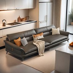 a living room filled with furniture next to a kitchen