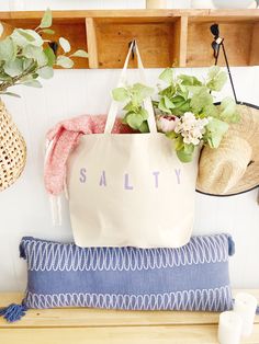 "The SALTY Oversized canvas tote bag is perfect for a trip to the beach! Also perfect to use as a reusable shopping bag, or everyday carryall. Available with text in several colors... check out the variations! This bag is made from 100% thick, sturdy canvas. AVAILABLE IN TWO SIZES * Large - 19.5\" x 13\" with a 4\" gusset *Jumbo - 23\" x 13\" with a 6\" gusset These bags are hand painted using non-toxic fabric paint. The technique used creates an attractive distressed appearance to the text that Summer Cotton Beach Bag For Shopping, Trendy Cotton Canvas Bag For Beach Season, Summer Cotton Canvas Bag With Letter Print, Cotton Beach Bag With Letter Print, Casual Cotton Beach Bag With Letter Print, Summer Cotton Canvas Shopping Bag, Cotton Beach Bags With Letter Print, Beach Season Cotton Canvas Tote Bag, Cotton Bags With Letter Print For Summer