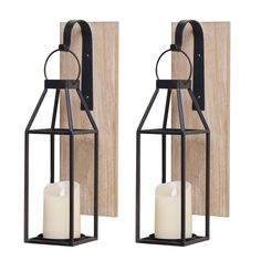 two black metal lanterns with white candles