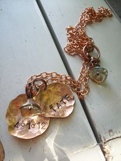 "❤️ Genuine copper pennies are pounded and pulverized into cool organic shapes. Solid copper chain holds the personalized medallions with names of the loved ones. Czech flower beads dangles. Extra medallions can be added for $10. each. Total chain length 20 inches. Each Medallion measures 1.25\" x 1.25\". Each is extremely unique and should only be ordered by lovers of the Rustic. Last pic shows a custom order. She used the second medallion for the birthdate. :) great idea! This necklace can be Nickel-free Copper Necklaces For Crafting, Hand Stamped Gold Copper Jewelry, Hand Stamped Copper Gold Jewelry, Copper Stamped Necklace For Gift, Copper Stamped Necklace Perfect For Gifts, Personalized Gold Copper Necklace, Copper Pennies, Flower Beads, Copper Necklace