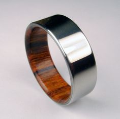 a wedding ring made out of wood and stainless steel