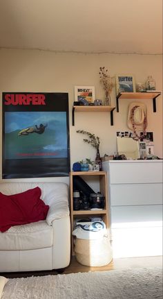 a living room with a white couch and shelves on the wall next to a book shelf