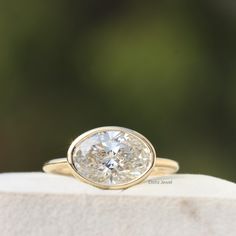 a diamond ring sitting on top of a rock