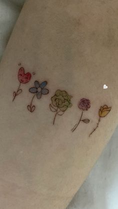 a woman's leg with flowers and hearts drawn on it