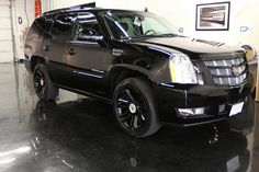 a black suv is parked in a garage