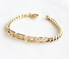 Because the best name to drop is your own.DETAILS- Crafted from genuine solid 14k gold- 9" length bracelet (standard men's size)- Chain style may vary slightly- Made in New YorkVARIATIONSIf you require any variation of this style (different chain length, etc.), feel free to message us. We will do our best to accommodate you. Additional costs may apply depending on the variation.POLICYThis item is made to order. Made to order items are final sale and sometimes require additional production time. Luxury Yellow Gold Name Bracelet For Gift, Luxury Elegant White Gold Name Bracelet, Modern Engraved Yellow Gold Name Bracelet, Charm Bracelets For Girls, Kids Gold Jewelry, Gold Necklace Indian Bridal Jewelry, Gold And Silver Bracelets, Lock Style, Mens Gold Bracelets