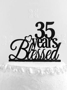 a black and white photo of a cake with the number 35 on it's top