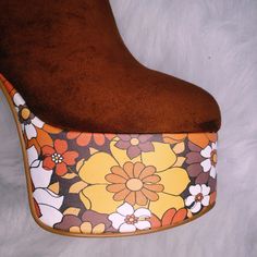 Elevate your style with the Suede Floral Platform Boots, a spin-off of the best-selling Suede Platform Heels. These boots feature a stunning '70s-inspired floral print on the platform, combining vintage charm with contemporary flair. Stunning '70s-inspired floral print on the platform for a unique and eye-catching look Crafted from high-quality suede for a luxurious feel and durability Perfect for nights out or adding retro glamour to everyday outfits. Retro Spring Heeled Boots With Round Toe, Retro Fall Heeled Boots, Retro Round Toe Heeled Boots For Spring, Vintage Brown Boots For Party, Retro Heeled Boots For Spring, Retro Platform Boots For Party, Retro Boots For Spring Party, Vintage Party Boots, Retro Round Toe Platform Boots For Spring