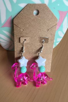 Dangle dinosaur earrings made with plastic beads 🦕 Hypoallergenic! Playful Plastic Dangle Jewelry, Handmade Plastic Dangle Earrings, Playful Pink Beaded Earrings, Goofy Earrings, Kidcore Earrings, Kawaii Shopping, Future Jewelry, Dinosaur Jewelry, Kidcore Aesthetic