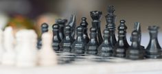 black and white chess pieces sitting on top of each other