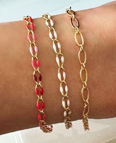 "Gold-filled Link Bracelet, White Enamel, Gold Bracelet, Red Ombre Enamel, and Gold Bracelet are all perfect for stacking! * Gold-filled link bracelet- 7\" * 18k Gold-plated white enamel bracelet- 7\" * 18k Gold-plated red ombre enamel Bracelet- 7\" * Lobster clasp closure Each bracelet comes in an organza jewelry pouch and gift box." Red Enamel Bangle Bracelets, Red Enamel Bangle Bracelet, Enamel Jubilee Bracelet As A Gift, Enamel Jubilee Bracelet For Gift, White Enamel Bracelets As A Gift, Red Enamel Bracelet Jewelry, White Enamel Bracelets For Gifts, Handmade Red Enamel Bracelets, Handmade Red Chain Bracelet Gift