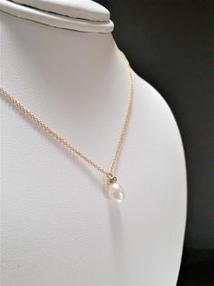 This dainty handmade necklace features a genuine Freshwater Pearl gemstone handmade using 14k Gold Filled in any length that you choose. This delicate solitaire necklace is handmade with just a simple wire wrap to give it the perfect delicate look. Beautiful worn alone or layered with other necklaces. Makes a great gift to add to any gemstone lover's collection. Perfect to gift for Christmas, Valentine's Day, Mother's Day, and more! Gemstone: Freshwater Pearl Gemstone Size: 8.0 mm Pearl Shape: T Simple Wire Wrap, Pearl Drop Necklace, Solitaire Necklace, Solitaire Necklaces, Pearl Gemstone, Freshwater Pearl Necklaces, June Birth Stone, Pearl Color, Drop Necklace