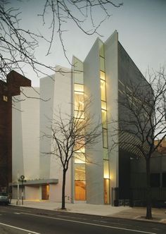 a large white building sitting on the side of a road