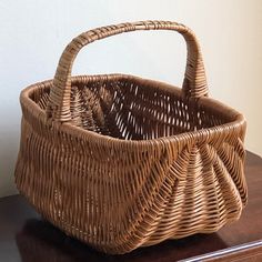 a wicker basket sitting on top of a wooden table