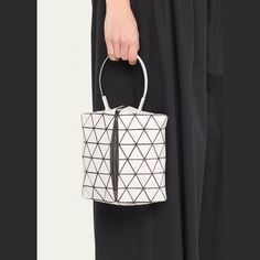 BAO BAO ISSEY MIYAKE "Torsos" top handle bag in PVC, polyester, and nylon/polyamide Top handle  Center zip closure  Interior, one slip pocket  Lining: Nylon Approx. 7.9"H x 7.5"W x 4.5"D Item Weight (Lbs.): 0.5 Made in Japan Modern White Nylon Shoulder Bag, Modern White Nylon Bags, Top Handle Nylon Bag With Removable Pouch, Nylon Top Handle Bag With Removable Pouch, Evening Nylon Shoulder Bag With Top Handle, Nylon Top Handle Bag With Detachable Handle, Evening Nylon Top Handle Shoulder Bag, Modern Nylon Top Handle Bag, Bao Bao Issey Miyake