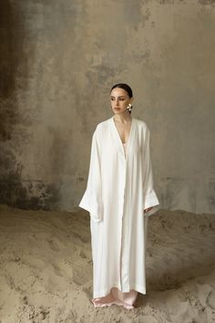 Introducing our stunning White Abaya, a true embodiment of elegance and style. ■ This exquisite WHITE KAFTAN dress and white maxi dress is expertly crafted from premium viscose fabric, known for its exceptional quality and luxurious feel. The unobtrusive and laconic embroidery, delicately made with silk threads, adds a touch of sophistication and refinement to this timeless piece. The pristine white color enhances its elegance, making it a versatile choice for any occasion. ■ Designed with versa Elegant White Floor-length Kimono, Elegant Long Sleeve Summer Abaya, White Floor-length Abaya, Summer Wedding Floor-length Abaya, Elegant Maxi Length Summer Thobe, Elegant Summer Maxi Thobe, Elegant Summer Maxi-length Thobe, White Oversized Maxi Dress, White Floor-length Summer Kaftan