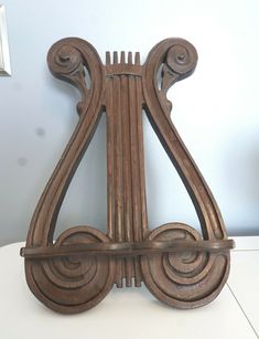 an old wooden musical instrument on a white table