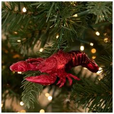 a red lizard ornament hanging from a christmas tree