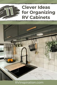 a kitchen with white tile and black cabinets, hanging utensils on the wall