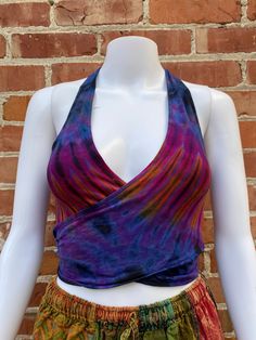 New tie up halter top  New style wrap top that can be worn multiple ways - tied in the front or in the back It's worn almost like a backpack because of the banding and strap details and you can wrap whichever way you prefer. It's stretchy and fits to your body.  Triangle stripe detail in the back  Vibrant tie dye colors - green, purple, grey, brown  Made from soft and stretchy fabric (rayon 95% / spandex 5%) One size - fits S-M best  ONLY PETITE SIZE  Unique and new style perfect for upcoming fe Purple Halter Neck Top For Spring, Stretch Purple Tops For Festival, Summer Crisscross Halter Top With Tie Back, Fitted Crisscross Halter Top With Tie Back, Beach Triangle Top With Crisscross Straps, Summer Fitted Crisscross Halter Top, Summer Cropped Halter Top For Yoga, Summer Vacation Crisscross Halter Top, Summer Yoga Halter Neck Top