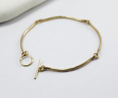 "A unique handcrafted golden arcs bracelet with a beautiful hammered shiny finish. This delicate special bracelet made from 24K gold plated with a handcrafted hammered clasp. Flattering simplicity -simply spacial and delicated jewelry. Each arc measures ~1.5\" (4cm) Total Length: ~ 71/4\" (18cm) Look at my shop from other items of this \"Gold Arcs\" collection: https://www.etsy.com/listing/81382391/curved-bar-necklace-double-strand https://www.etsy.com/listing/163510683/curved-bar-earrings-gold- Gold Bar Earrings, Stick Earrings, Curved Bar, Bar Bracelet, Dainty Bracelet, Hammered Gold, Bar Bracelets, Dainty Bracelets, Bar Earrings