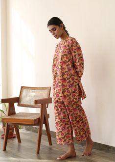 The set consists of printed shirt, 3/4th sleeves, collar neck teamed with printed palazzo pants. Fabric-Cotton Color-Peach Kurta Length length -28 inches Pant Length-38 inches Style - Floral Print detailing Neck - Collared neck Sleeves - 3/4th bell sleeves Model is wearing size small. She is 5.8‚Äù tall. Washing Care- Hand wash & Dry Clean Pink Long Sleeve Palazzo Set For Spring, Spring Pink Long Sleeve Palazzo Set, Cotton Floral Print Sets With Straight Pants, Floral Print Cotton Sets With Straight Pants, Cotton Sets With Floral Print Straight Pants, Straight Kurta Sets With Printed Motifs For Work, Workwear Sets With Printed Motifs And Straight Kurta, Pink Long Sleeve Palazzo Set For Summer, Pink Block Print Sets With Long Sleeves