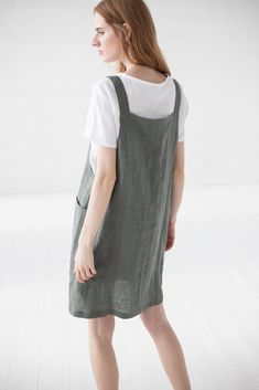 "DETAILS * Short pinafore dress with two deep pockets at the front * Functional down buttons at the front * Combine with all style blouses * Made from soft wash medium weight (185 g) 100 % European linen fabric * Height of the model is 177 cm (5' 8\") and she is wearing dress in size XS/S and sage green color * The full dress length is 93 cm / 36.6'' * Please choose desired color and size on the right * Product number: D16 CARE LABEL * machine wash gentle (40 C/104 F) * dry gentle on low heat * Spring Pinafore Dress With Pockets For Work, Spring Workwear Pinafore Dress With Buttons, Spring Workwear Pinafore Dress With Pockets, Casual Sleeveless Pinafore Dress With Pockets, Casual Dresses With Adjustable Straps For Work, Casual Spring Suspender Dress For Work, Casual Work Dresses With Adjustable Straps, Casual Workwear Dress With Adjustable Straps, Spring Casual Bib Front Pinafore Dress