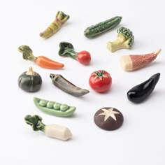 several different types of vegetables on a white surface