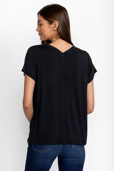 Crafted from a super soft modal blend with a hint of stretch, the Modal Jersey Button Neck Tee offers a modern take on classic sportswear. Featuring a curved V-neckline with decorative buttons, this short sleeve tee creates a relaxed fit with a custom feel. Pair with linen shorts and fashion sneakers to take on the warmest days. Johnny Was Women's Modal Jersey Button Neck T-Shirt in Black Beauty White, Size Small, Linen Everyday Black Tops With Shirttail Hem, Black Everyday Tops With Shirttail Hem, Solid Crew Neck Top In Modal, Solid Modal Crew Neck Top, Solid Color Modal Crew Neck Top, Casual Soft Stretch Tops For Loungewear, Versatile Loungewear Tops With Shirttail Hem, Solid Color V-neck Athleisure Top, Casual Modal Top With Relaxed Fit