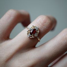 Heirloom Red Cluster Ring With Birthstone, Red 14k Gold Cluster Ring With Birthstone, Gold Garnet Cluster Promise Ring, Red Birthstone Cluster Ring In 14k Gold, Gold Engagement Ring Garnet, Gold Garnet Birthstone Ring With Center Stone, Gold Oval Garnet Cluster Ring, Vintage Garnet Promise Ring, Oval Garnet Cluster Ring In Gold