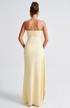 Be obsessed with Zafira, our timeless maxi made in luxury stretch crepe that moulds to your body for a heavenly fit. With a strapless neckline and pleated detailing, this showstopping look has a thigh high split and drape to one side. 



Colour: Lemon.

Premium stretch crepe fabric.

Fully lined.

Strapless.

Pleated panel on bust.

Asymmetric pleats on waist.

Moulds to body figure.

Thigh high split.

Drape detail.

Invisible zipper to the reverse.

Maxi length.

Model is an XS and is wearing an XS.

 Size: XS, S, M, L, XL, XXL Split Long Dress, Vest Blouse, Body Figure, Maxi Dress Sale, Strapless Neckline, Maxi Dress Navy, Stretch Crepe, Dress Pant, Crepe Fabric