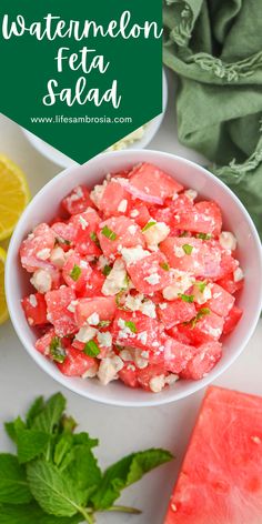 watermelon feta salad in a white bowl surrounded by sliced lemons and mint