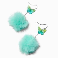 pair of butterfly earrings with turquoise fur ball and dangling earwires on white background